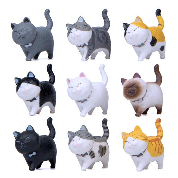 Fröhliche Mini Katzenfigur mit drehbarem Kopf, bringt Leben in jede Wohnungseinrichtung.