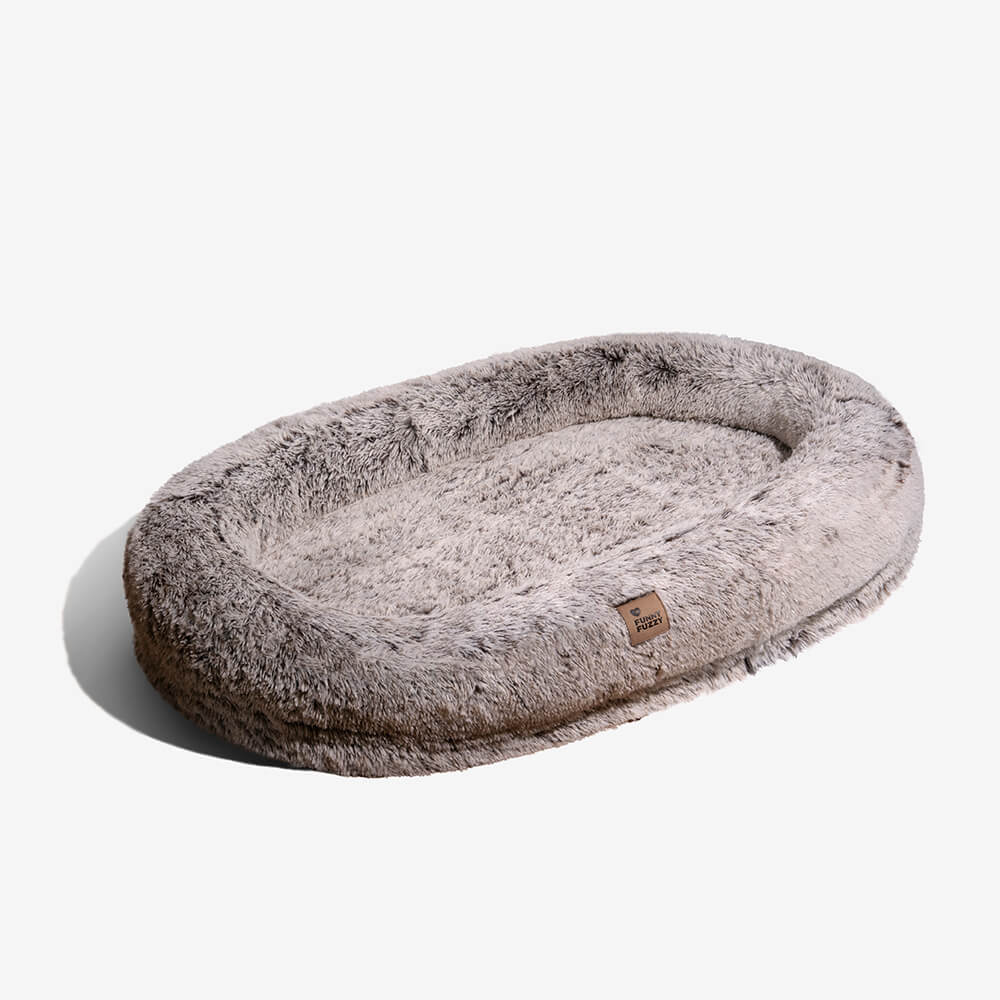 Gemütliches Donut-Hundebett für Welpen, orthopädisch & schützt kleine Gelenke.