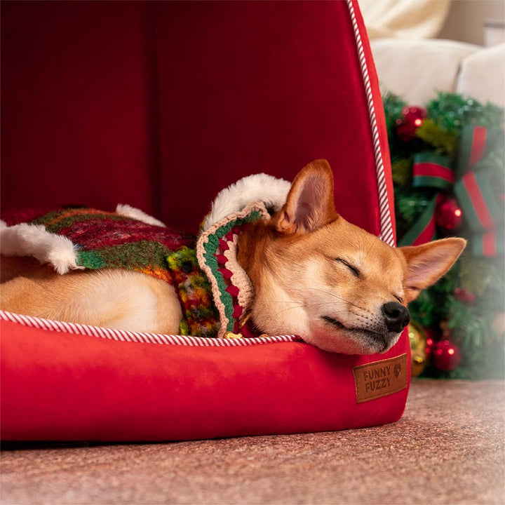 Gemütliches rotes Hundebett, orthopädisch, im Schneehaus-Design, perfekt für kalte Winterabende.