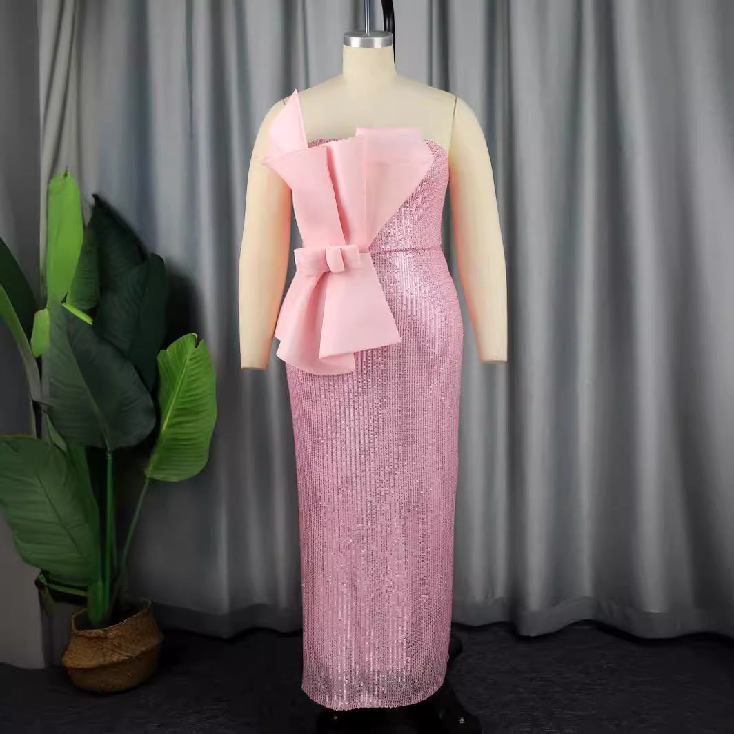 Glamouröses rosa Glitzerkleid für Damen mit asymmetrischem Schnitt und auffälliger Schleife, ideal für Partys.