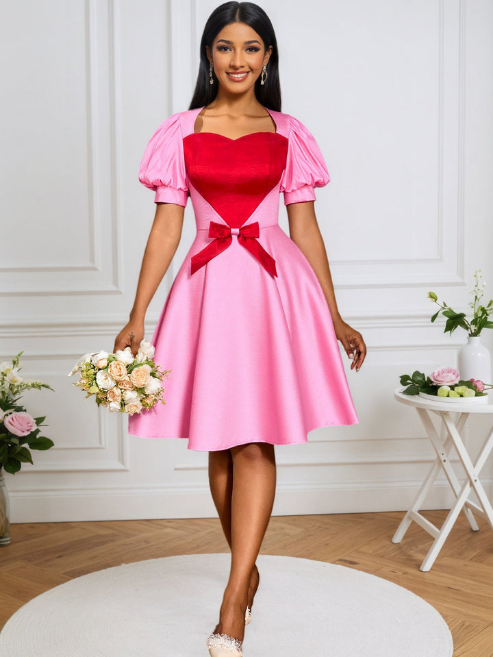 Tailliertes rosafarbenes Damenkleid, elegant und festlich, mit stilvollem Herz-Ausschnitt & modernen Puffärmeln.