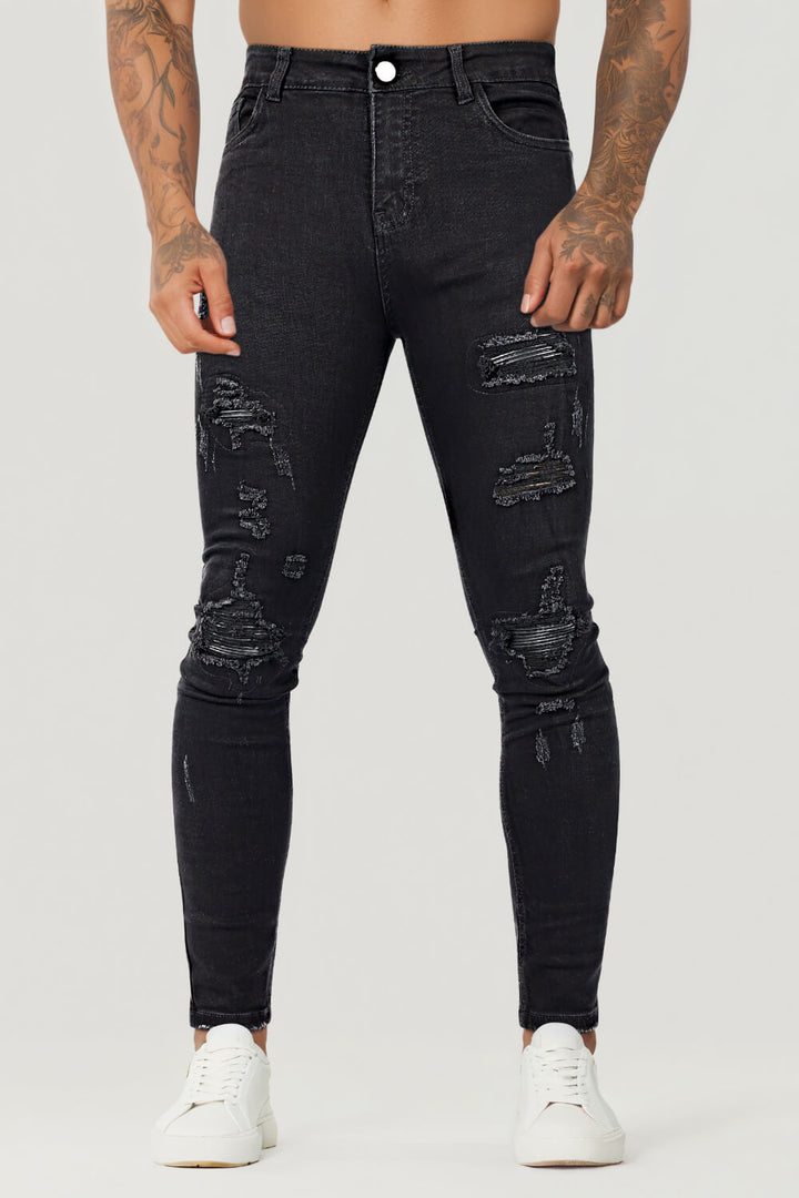 Trendige schwarze zerrissene Slim Fit Jeans für Herren, ein Must-have für Streetwear-Mode.