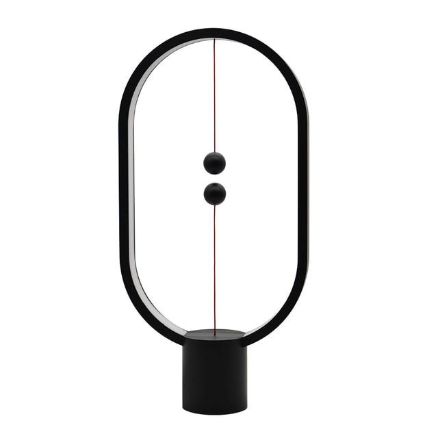 Schwarze LED Balance Lampe mit Magnetschalter, elegantem Design, ideal als Schreibtischlampe oder Dekoration.