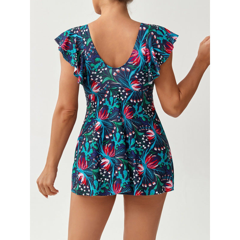 Stylischer Damen Strandbadeanzug mit floralem Muster, V-Ausschnitt und Raffung, ideal für Pool und Meer.