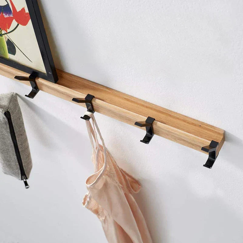 Funktionale Wandgarderobe mit beweglichen Doppel-Haken aus Holz & Metall für flexible Ordnung im Schlafzimmer.