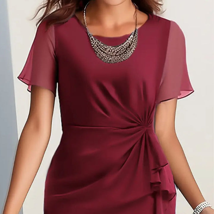 Feminin elegantes Damenkleid mit Rundhals & kurzen Ärmeln; ideal für Anlässe.