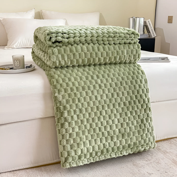 Detailaufnahme der luxuriösen Mikrofaser-Kuscheldecke. Extrem weich, warm und langlebig für alle Räume.