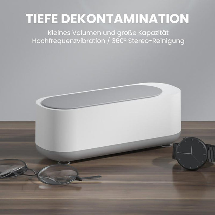Tragbarer Ultraschallreiniger säubert Schmuck und Brillen gründlich; ideal für Tiefenreinigung zu Hause.