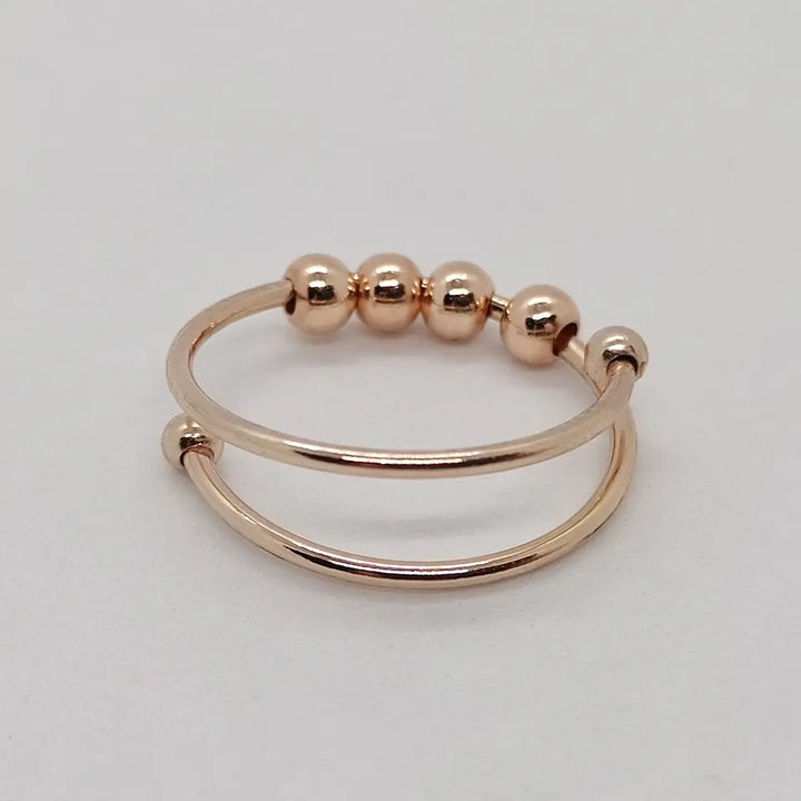 Stilvoller Unisex Spinner-Ring in Roségold, ideal als Geschenk, hilft bei Stress und Angst durch sanftes, beruhigendes Drehen.