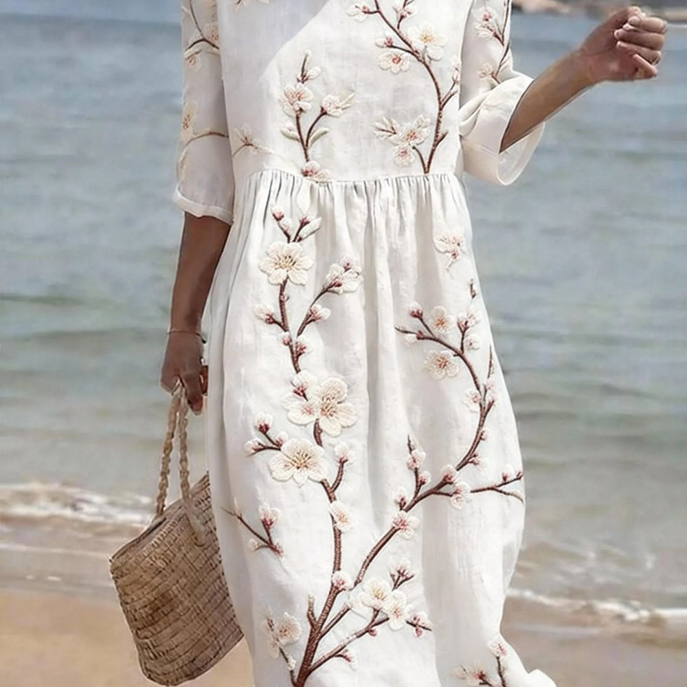 Feminin-lässiges Blumen-Midikleid für Damen mit Ellenbogenärmeln, ideal als Sommer- oder Freizeitkleid.